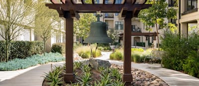Garden pathway with landscaping and a bell