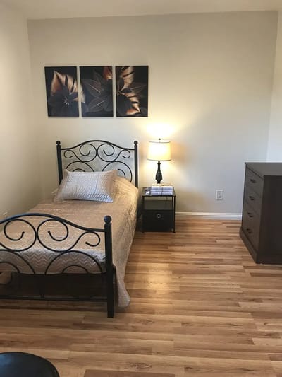 Cozy resident room with bed and dresser