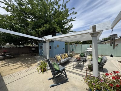 Outdoor seating area with plants and shaded patio
