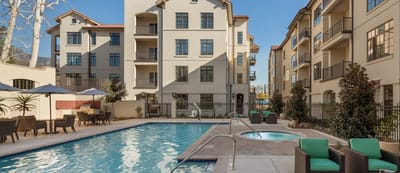 A beautiful pool area surrounded by the facility buildings