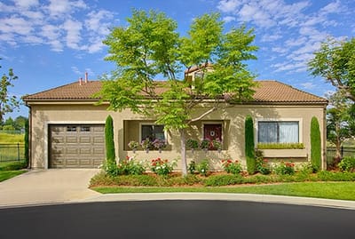 Exterior view of a senior care facility with garden