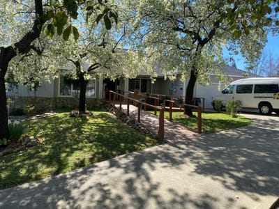 Front entrance of Oak Hill Senior Care surrounded by trees