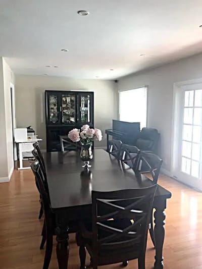 Bright dining room with a large table and floral centerpiece