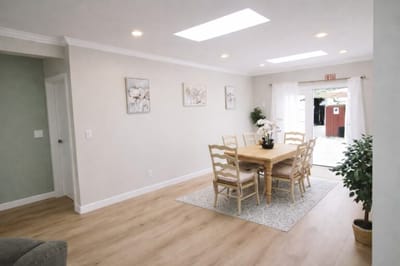 Bright common area with a dining table and chairs