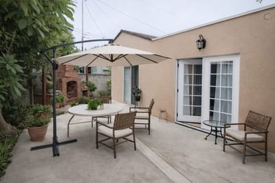 Outdoor seating area with umbrella and plants