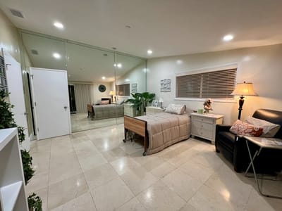 A well-furnished resident room with natural light