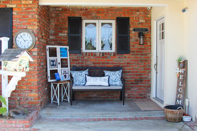 Welcoming porch area with a bench and decorative accents