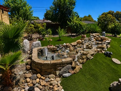 Beautiful landscaped outdoor space with a water feature