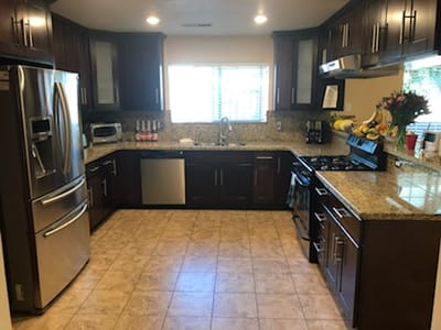 Modern kitchen with stainless steel appliances and granite countertops