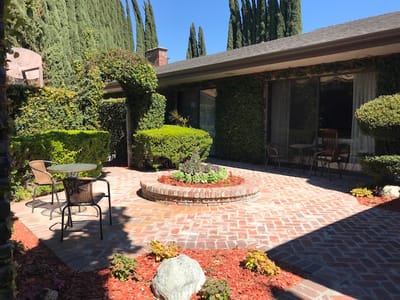 A serene outdoor courtyard with seating and greenery