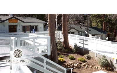 Exterior view of Pacific Pines community with logo