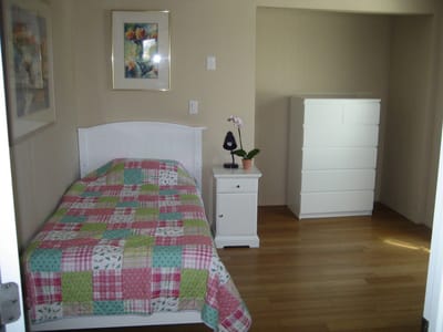 A private room with a bed and dresser