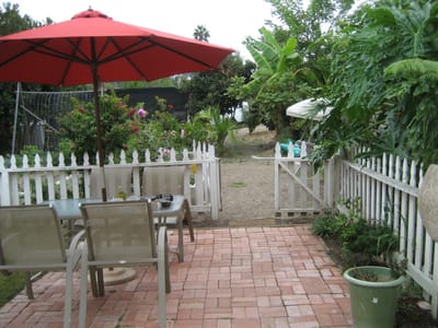 Outdoor patio area with a dining table and umbrella