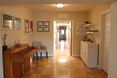 Bright hallway with a piano and decorations
