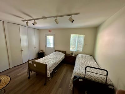 A double occupancy resident room with beds and natural light