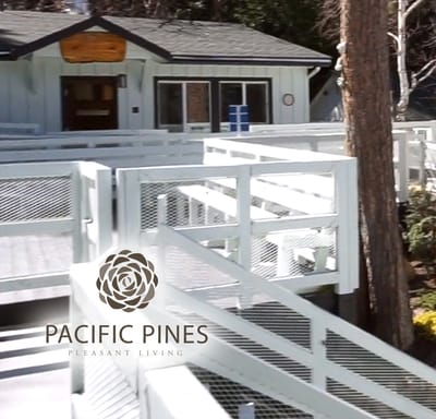 Exterior view of Pacific Pines with a logo