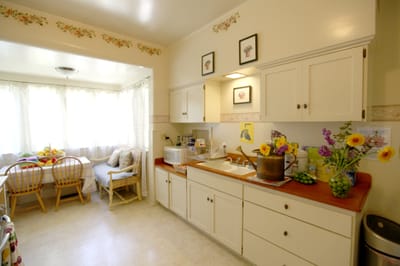 Bright kitchen area with floral decor and seating