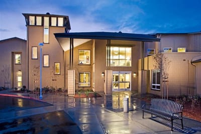Exterior view of The Parkview facility at dusk