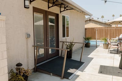 Entrance with accessible ramp and outdoor area