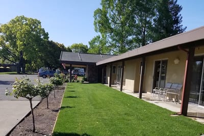 Exterior view of Piner's Guest Home with landscaped area