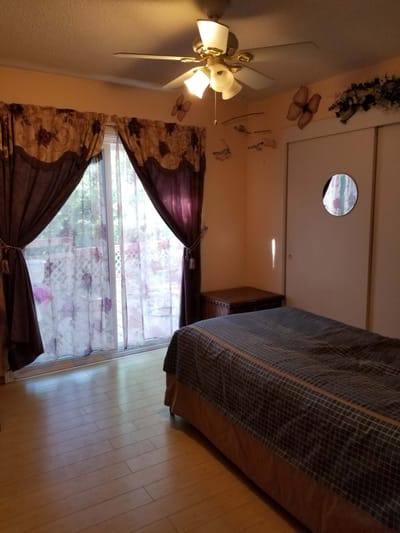 Cozy private room with bed and curtains