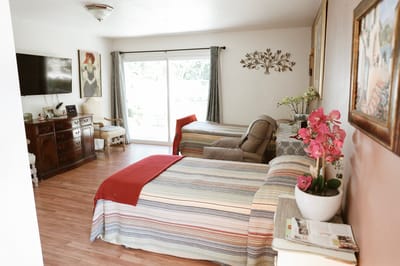 Cozy shared room with colorful bedding and natural light