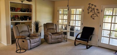 Cozy lounge area with recliners and decor