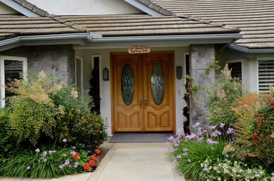 Entrance of Park View Villa surrounded by flowers