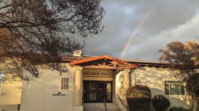Exterior view of Decker Hall with rainbow