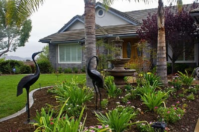 Exterior view of a facility with garden and sculptures