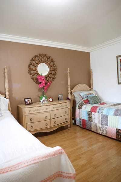 Cozy resident bedroom with two beds and decor