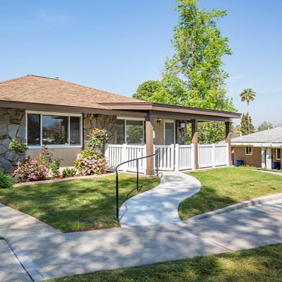 Exterior view of a senior living facility with landscaping
