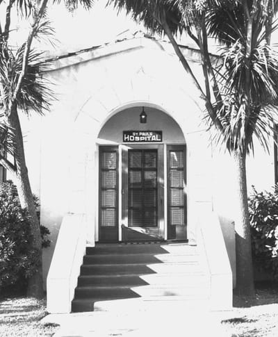 Entrance to St. Paul Hospital with palm trees