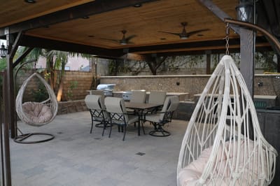 Outdoor dining area with seating and grill