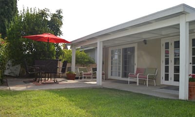 Outdoor patio area with seating and umbrella