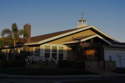 Exterior view of a senior living facility with landscaping