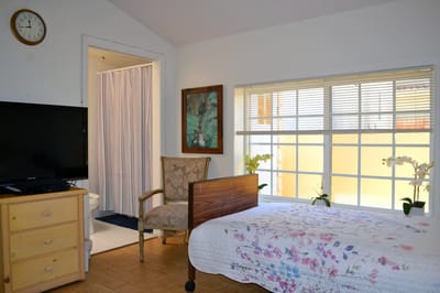 Bright resident room with bed and seating