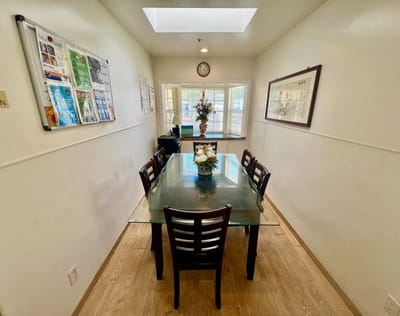 Bright interior room with a glass table and flowers