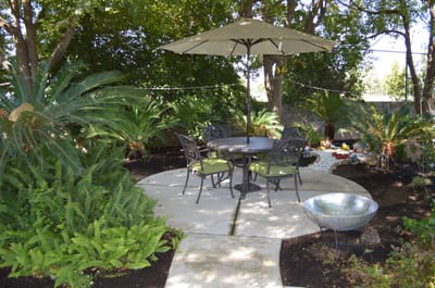 Serene outdoor patio area with seating and greenery
