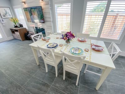 Bright dining area with a large table set for meals
