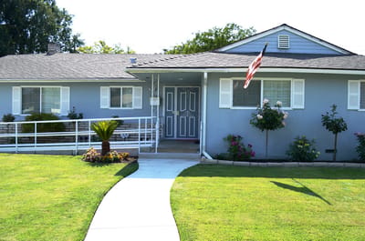 Exterior view of a senior living facility with garden