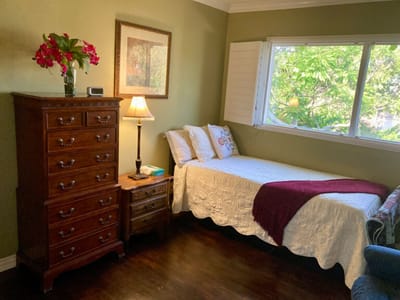 Cozy private room with a bed and furniture