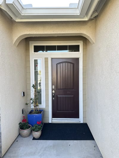 Entrance door of a care facility with potted plants