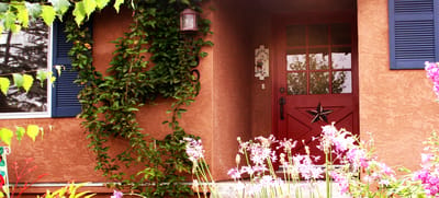 Charming entrance with flowers and a red door