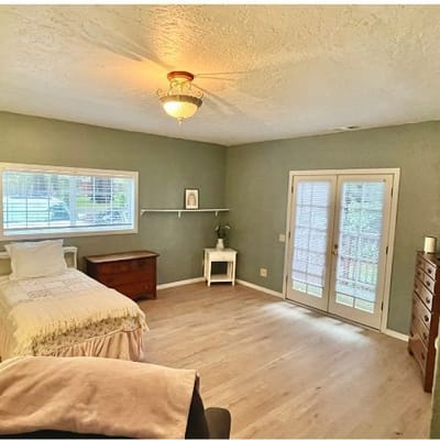 A simple and spacious private room with a window