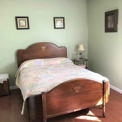 Cozy private bedroom with a wooden bed