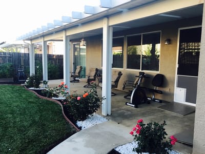 Outdoor seating area with flowers and exercise equipment