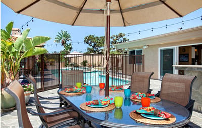 Outdoor dining setup by the pool with vibrant decor