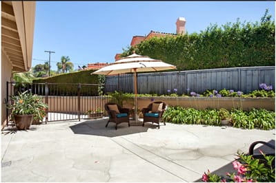 Outdoor seating area with umbrella and plants