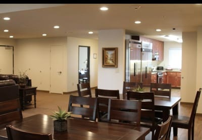 Dining area with tables and kitchen view